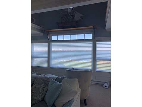 Traditional living room with large windows and soft lighting